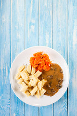 Potato noodles - dumplings on wooden background 