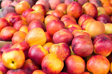 Fototapeta na wymiar Nectarines background. Nectarine fruits on a market