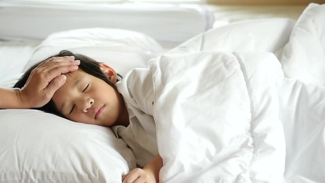 Cute Asian child sleeping on white bed with mother care slow motion 