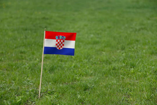 Croatia flag, Croatian flag on a green grass lawn field background. National flag of Croatia waving outdoor