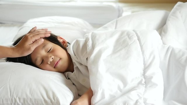 Cute Asian child sleeping on white bed with mother care slow motion 