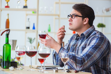 Professional sommelier tasting red wine 