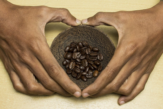 coffee concept - roasted coffee beans with shape of love hand  