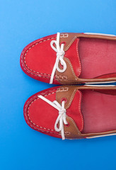 Red ballet shoes isolated on the blue background.