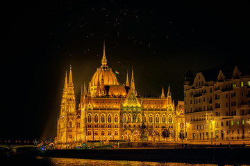 Naklejka premium The Hungarian Parliament Building is the seat of the National Assembly of Hungary, one of Europe's oldest legislative buildings, a notable landmark of Budapest. Night-view with Danube river.