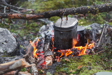 Cooking in a pot over the fire in the hiking camp