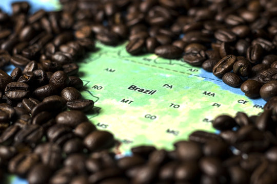coffee concept - roasted coffee beans with a map background of Brazil.