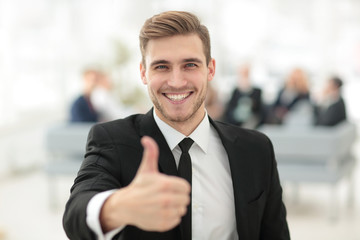 portrait of happy businessman showing thumb up.