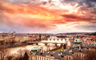 Fototapeta na wymiar Epic sunset scenery of Prague at Twilight, panorama of Bridges on Vltava, aerial view, beautiful bridges vista. Winter season. Prague is famous and very popular travel destination. Czech Republic.