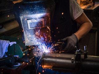 Use of wire welding machine in a workshop.
