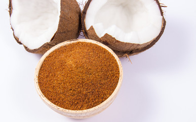 Coconut with coconut sugar isolated on white background.