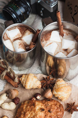 Metal mugs with cacao and marshmallows
