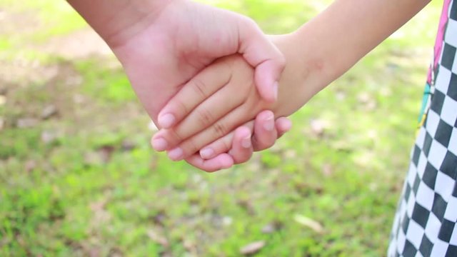 Asian little girls holding hands couple together show Relationship between sister and family at garden outdoor, Love parents friendship concept.