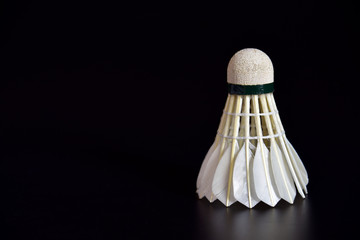 Badminton ball or shuttle cock on the black background with copy space for advertising, Sport concept, Fitness concept