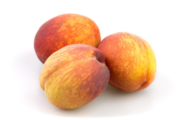 Red and yellow peaches isolated  on white background in studio
