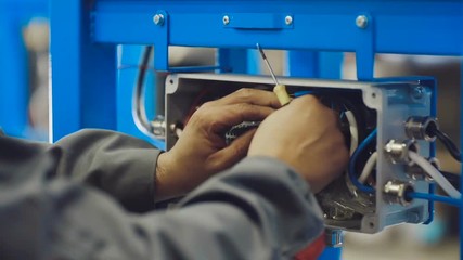 Electrician Whit Electrical Cables. Engineer at work with electric