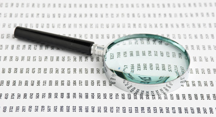 magnifying glass and document with figures