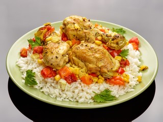 Cuban roasted chicken legs with rice on the plate