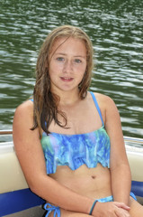 Young teen girl sitting in a boat.