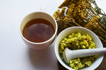 medicinal herb, bunch of different dried herbs and a Cup of brewed herbal tea