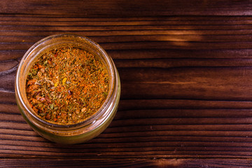 Mix of different seasonings in glass jar. Top view