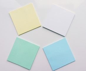 Four square sheet of paper on a white background. Top view. Close-up