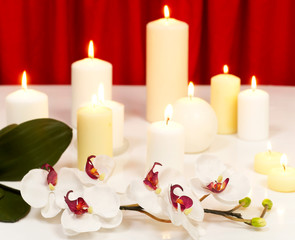 Fototapeta na wymiar Lit candles and orchid