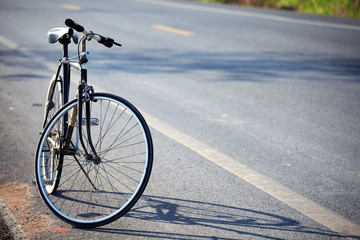 Fototapeta na wymiar vintage bicycle beside the road