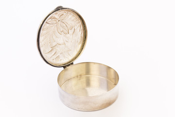 A beautiful vintage silver jewellery box with flower ornament and open lid on white background.
