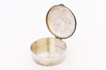 A beautiful vintage silver jewellery box with flower ornament and open lid on white background.