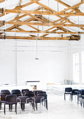 Wooden Roof Structure in White Bright Interior. Old Rafters in the Loft Interior