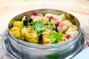 Mixed chinese steamed dumpling (dim sum), crab stick, ha gow, seaweed, coriander and garlic for background or texture - food chinese concept.