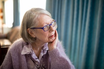 Thoughtful senior woman looking away