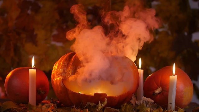 Glowing smoking monster pumpkin. Halloween concept