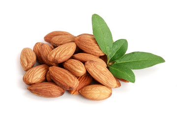 Group of almond nuts with leaves isolated on white background