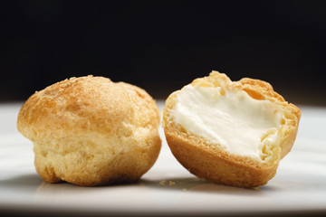 profiteroles on plate closeup one sliced