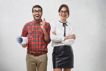 Glad hopeful male geek or wonk keeps fingers crossed, worries before presentation of new project,...