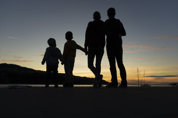 Family walking outdoors at sunset