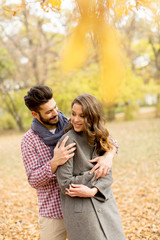 Fototapeta premium Lovely young couple in the autumn forest
