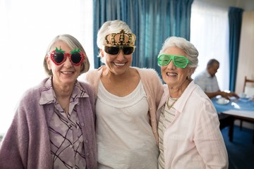 Smiling senior women wearing novelty glasses