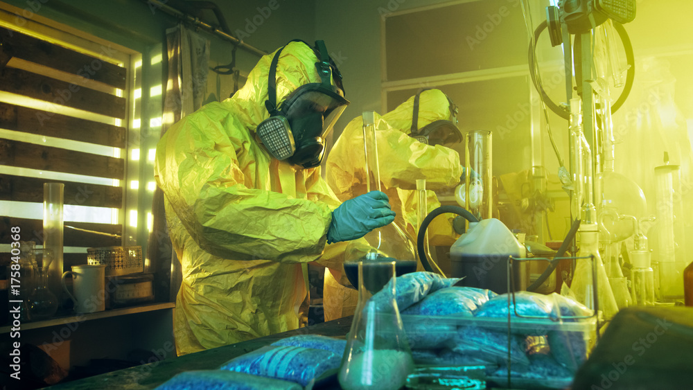 Wall mural in the underground laboratory two clandestine chemists wearing protective coveralls and masks cook d