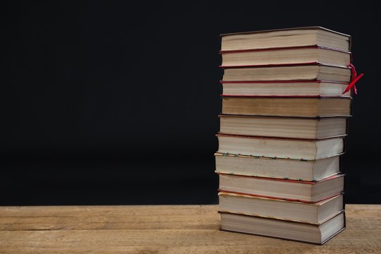 Stacked Books On Wooden Table