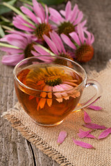 Cup of echinacea tea on old wooden table