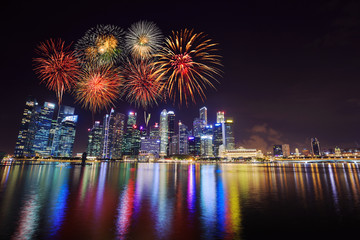 firework over central business district building of Singapore city at night