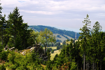 Fototapeta premium Vast panorama view from the forested hill in the Owl Mountains (Gory Sowie) Landscape Park, Sudetes, countryside landscape in south-west Poland.
