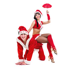 Obraz premium Happy young couple wearing santa claus clothes