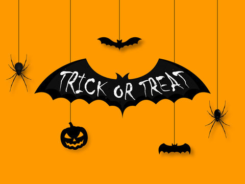 Happy halloween. Trick or treat calligraphy on black bat. Hanging on ropes spiders and pumpkin. Banners party invitation.Vector illustration.