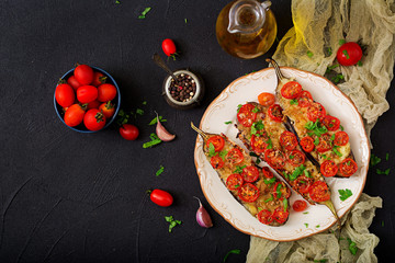 Baked eggplants with mozzarella and tomatoes with Italian herbs. Flat lay. Top view