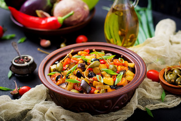 Hot spicy stew (caponata) eggplant, zucchini, sweet pepper, tomato, carrot, onion, olives and capers