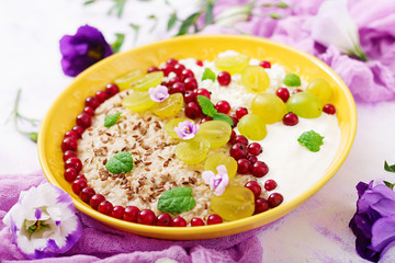 Delicious and healthy oatmeal with grapes, yogurt and cottage cheese. Healthy breakfast. Fitness food. Proper nutrition.